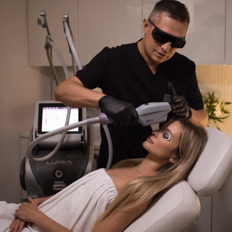 Clinician performing an aesthetic treatment with the DEKA Luxea Plus platform