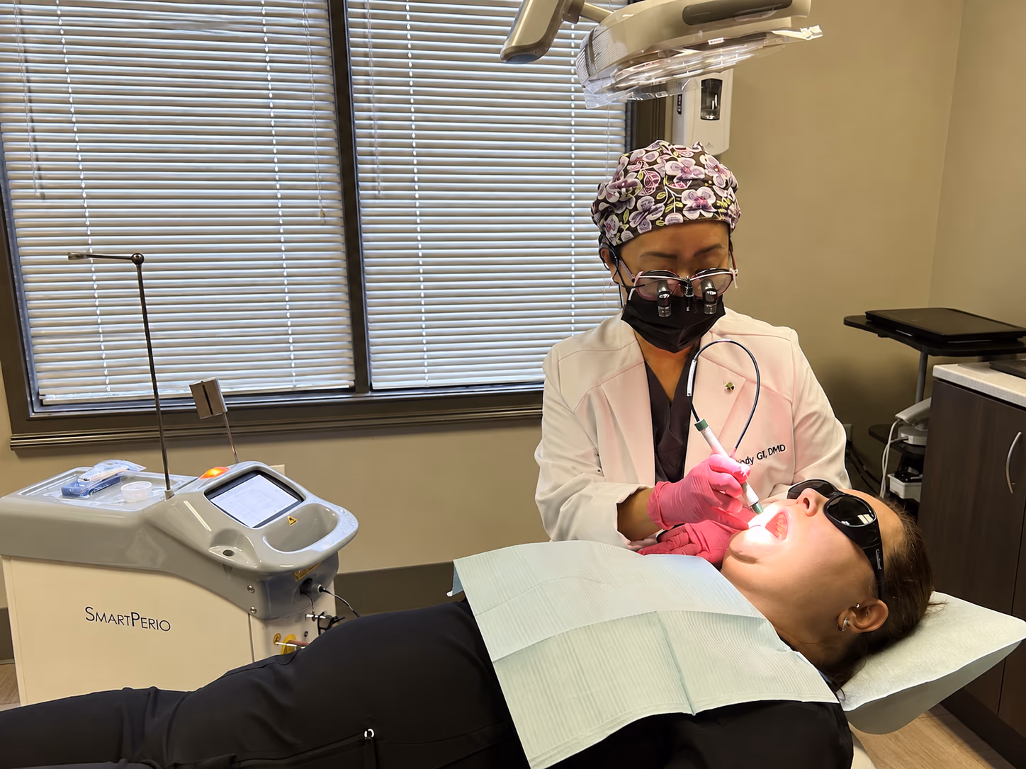Clinician delivering Nd:YAG laser therapy chairside with the DEKA SmartPerio